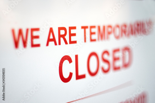 Sign in a shop window: We are temporarily closed. Covid-19 isolation and closed shops.