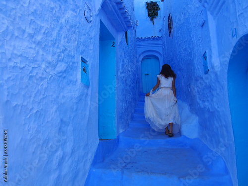 A bride walks the steps of the beautiful blue old town, Medina, Chaouen (Chefchaouen), Morocc © Mithrax