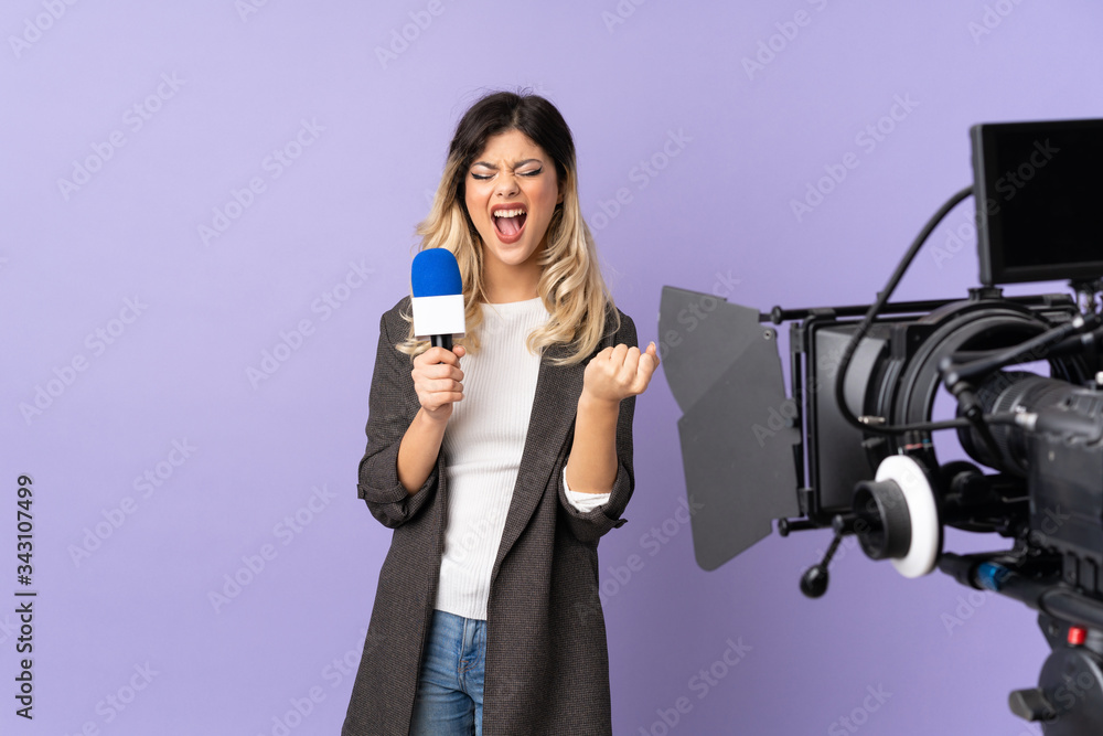 Fototapeta premium Reporter teenager girl holding a microphone and reporting news isolated on purple background frustrated by a bad situation