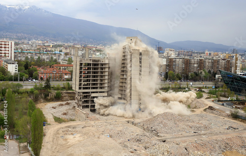 Controlled explosion with blasts of a unfinished and abandoned empty high building, printing press house IPK Rodina, in Sofia, Bulgaria on 04/26/2020. photo