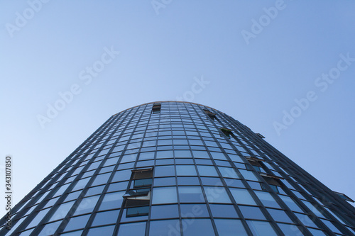 Huge glass business building on blue sky background