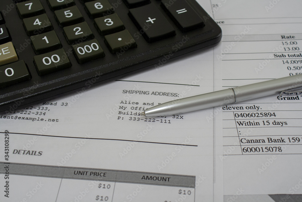 Macro shot of calculator , pen and documents with figures Macro shot of calculator , pen and documents with figures