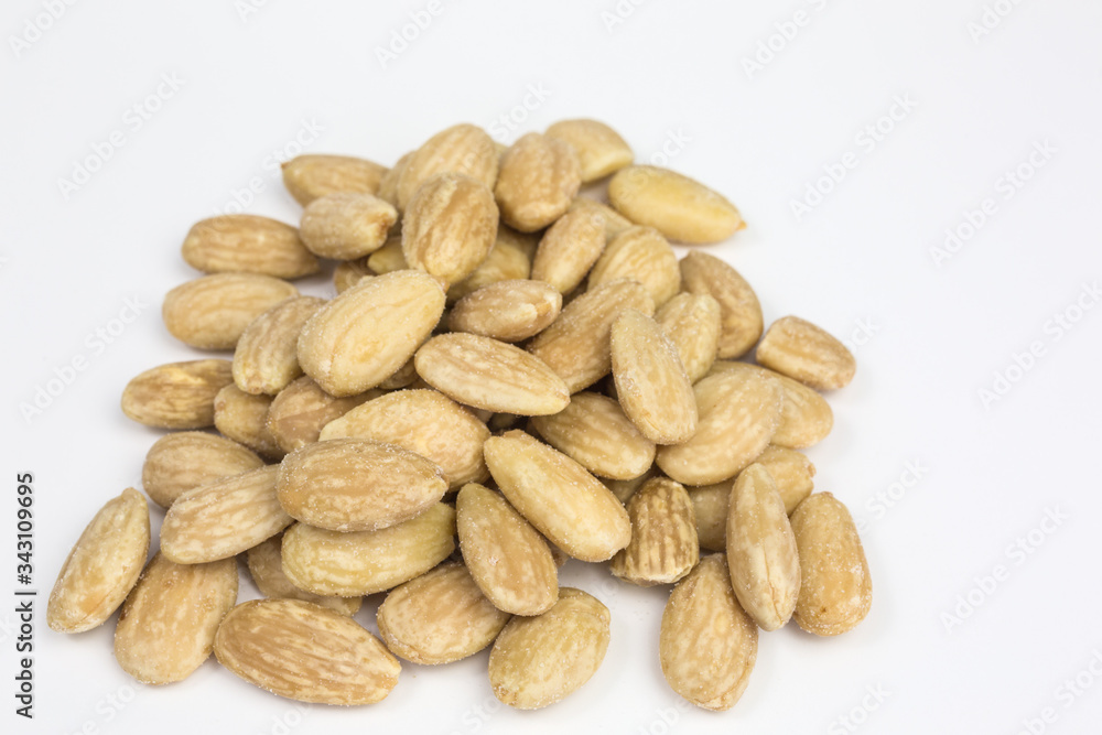 heap of salted roasted almonds for a healthy snack heap of salted roasted almonds for a healthy snack
