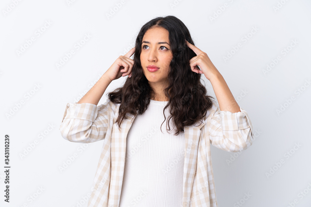 Mixed race woman over isolated white background having doubts and thinking Mixed race woman over isolated white background having doubts and thinking