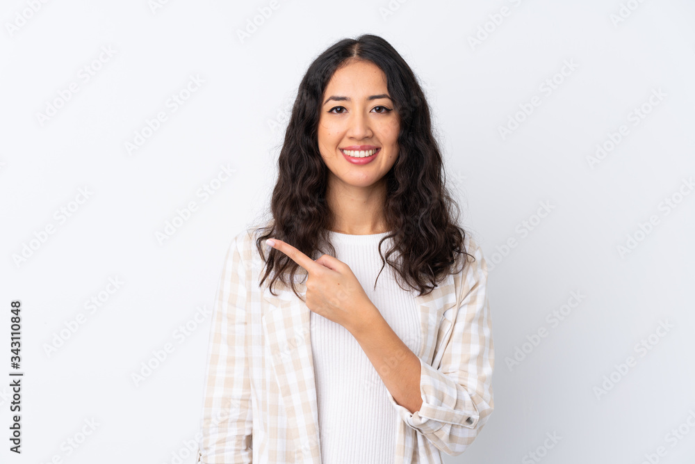 Mixed race woman over isolated white background pointing to the side to present a product Mixed race woman over isolated white background pointing to the side to present a product