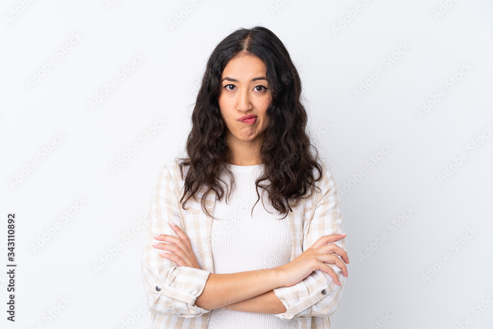 Mixed race woman over isolated white background feeling upset Mixed race woman over isolated white background feeling upset