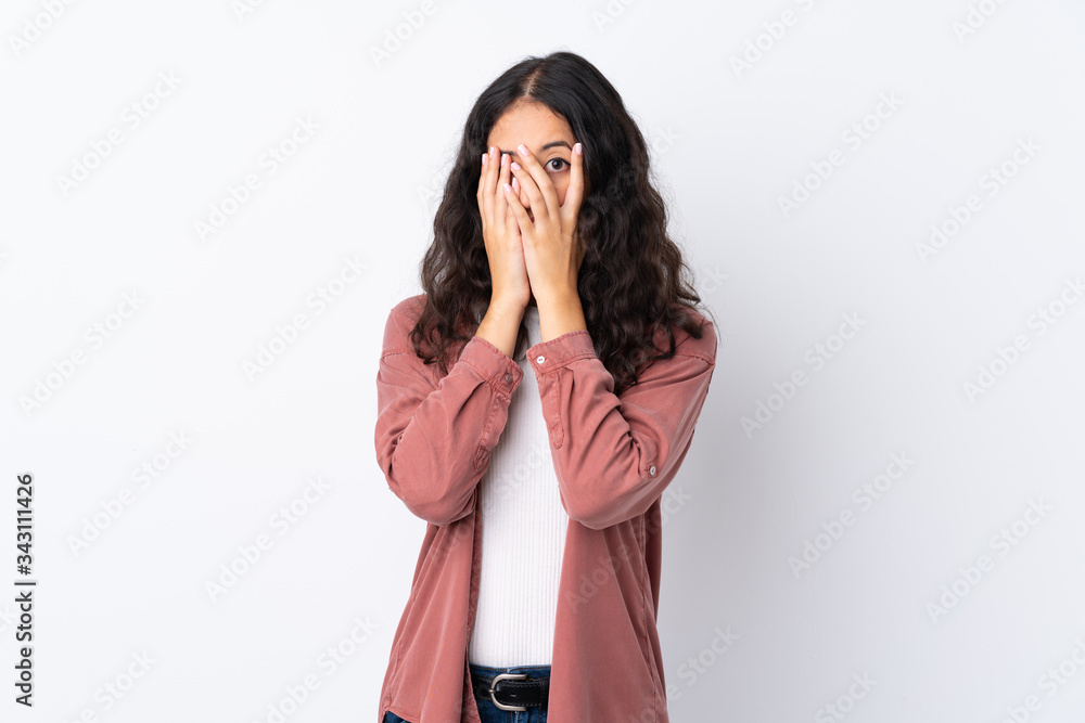 Spanish Chinese woman over isolated white background covering eyes and looking through fingers Spanish Chinese woman over isolated white background covering eyes and looking through fingers