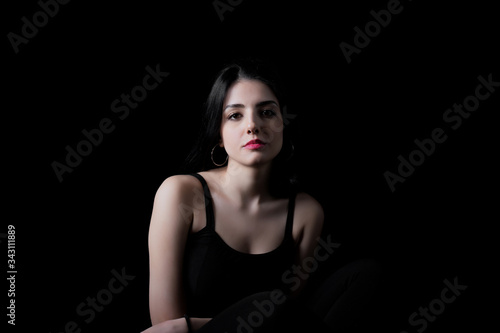 Young woman looking at camera isolated on black background. Beautiful woman portrait. © ErdalIslak