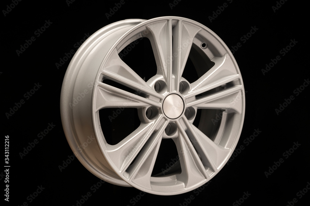 Obraz premium new aluminum alloy wheel, silver color on a black background