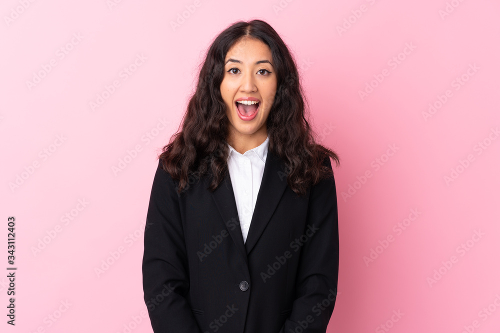 Mixed race business woman over isolated pink background with surprise facial expression Mixed race business woman over isolated pink background with surprise facial expression