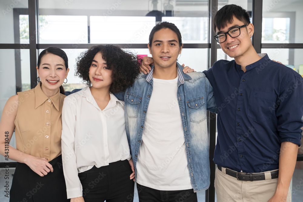 © saksit - Portrait of Asian creative business team. Hipster Creative Startup Young business people in modern office. © saksit - Portrait of Asian creative business team. Hipster Creative Startup Young business people in modern office.