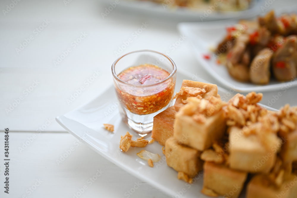 Deep fried tofu is cut into square balls on plate Deep fried tofu is cut into square balls on plate