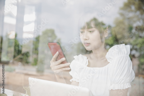 Female holding phone and looking on his screen.