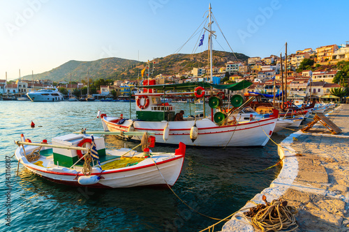 Beautiful traditional fishing boats in Pythagorion port at sunset time, Samos island, Greece