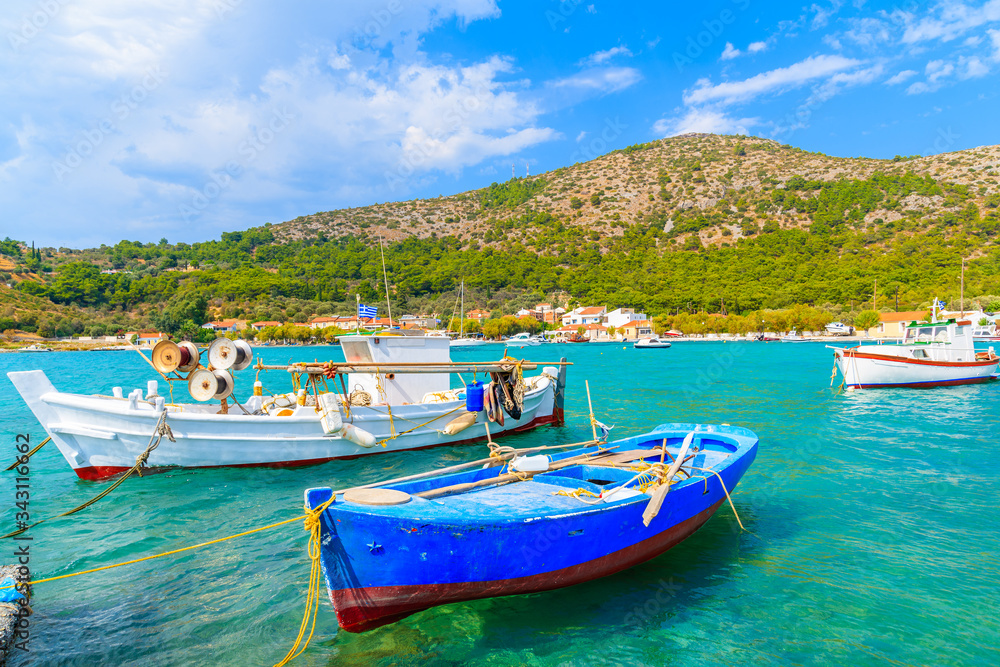 Colourful Greek fishing boats on turquoise sea in Posidonio bay, Samos island, Greece