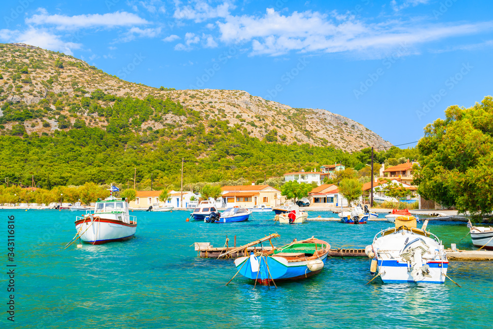 Colourful Greek fishing boats on turquoise sea in Posidonio bay, Samos island, Greece