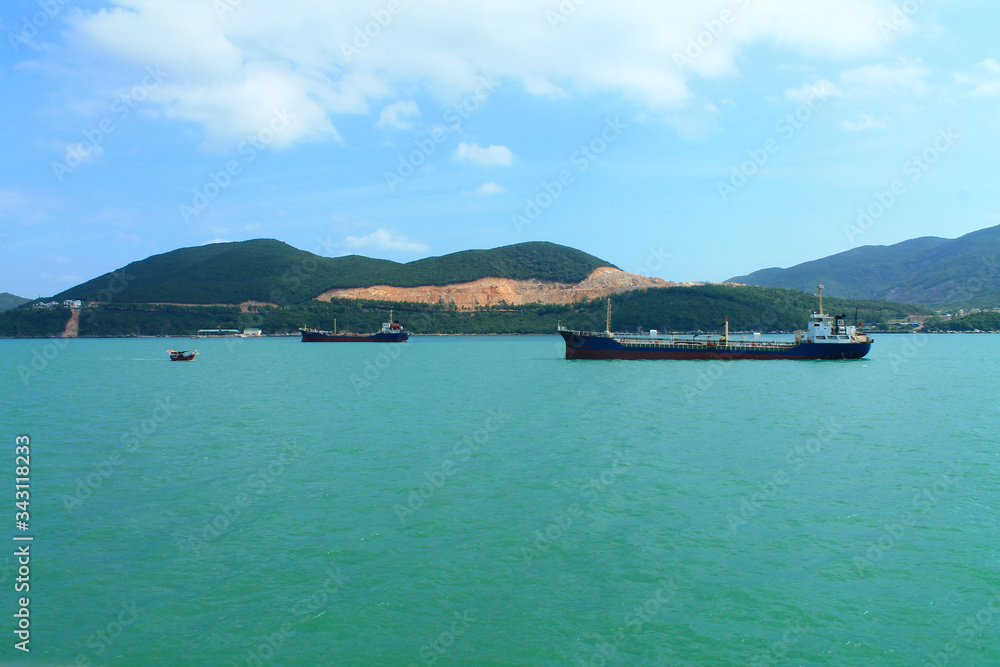 A scenic view of the mountain islands and boats near the city of Nha Trang. Turquoise Sea in Vietnam