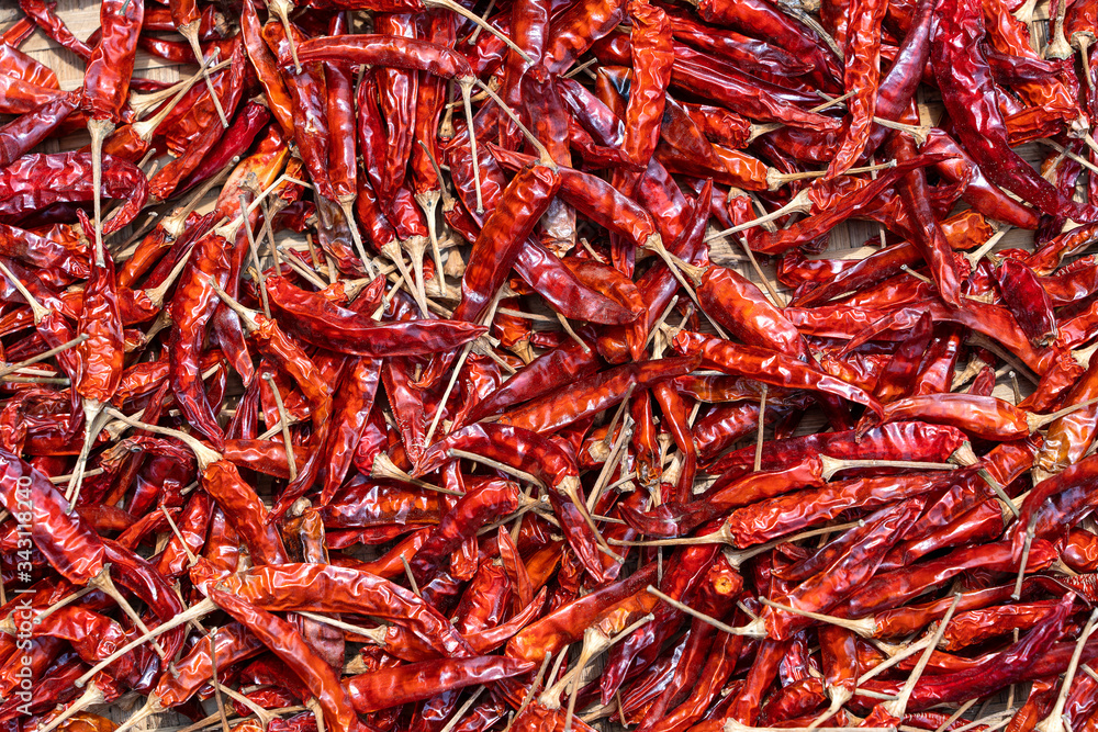 Fototapeta premium Red dry hot chili peppers for sale at street food market in Vietnam. Close up