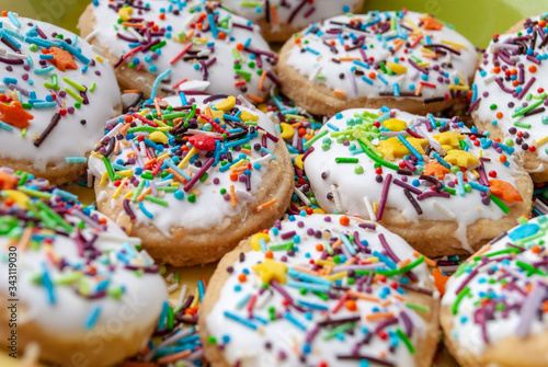 texture, background, baking cream dessert sweet, happy easter. glaze. multi-colored topping, cookies on a plate