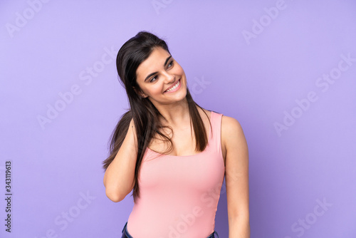 Young woman over isolated purple background thinking an idea