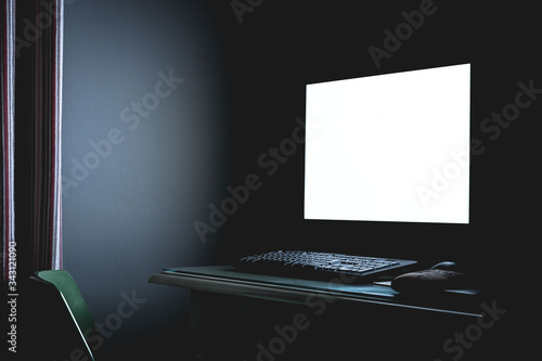 Photography Dark room with white screen next to keyboard and on desk with chair