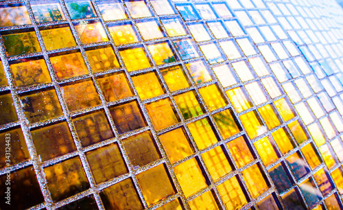 Abstract golden yellow square mosaic tiles for textured backgrounds. Beautiful repeat patterns.