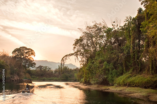 Boat trip on the river Kwai. Sunset over the river and the jungle. Thailand