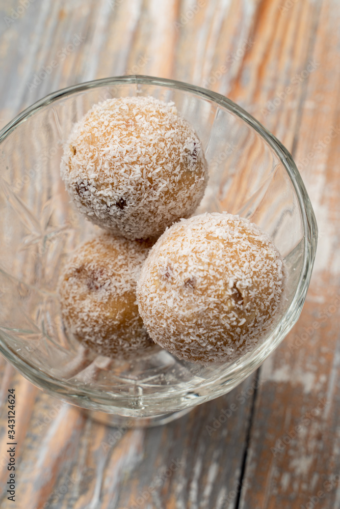 Cake-pops made of sponge cake, coconut and chocolate in a glass bowl Cake-pops made of sponge cake, coconut and chocolate in a glass bowl