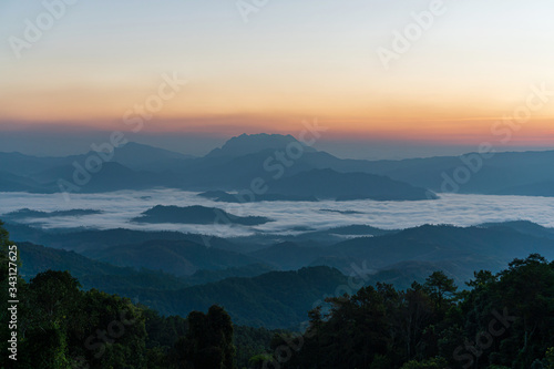 Beautiful sunrise and colorful sky in the mist over the mountain