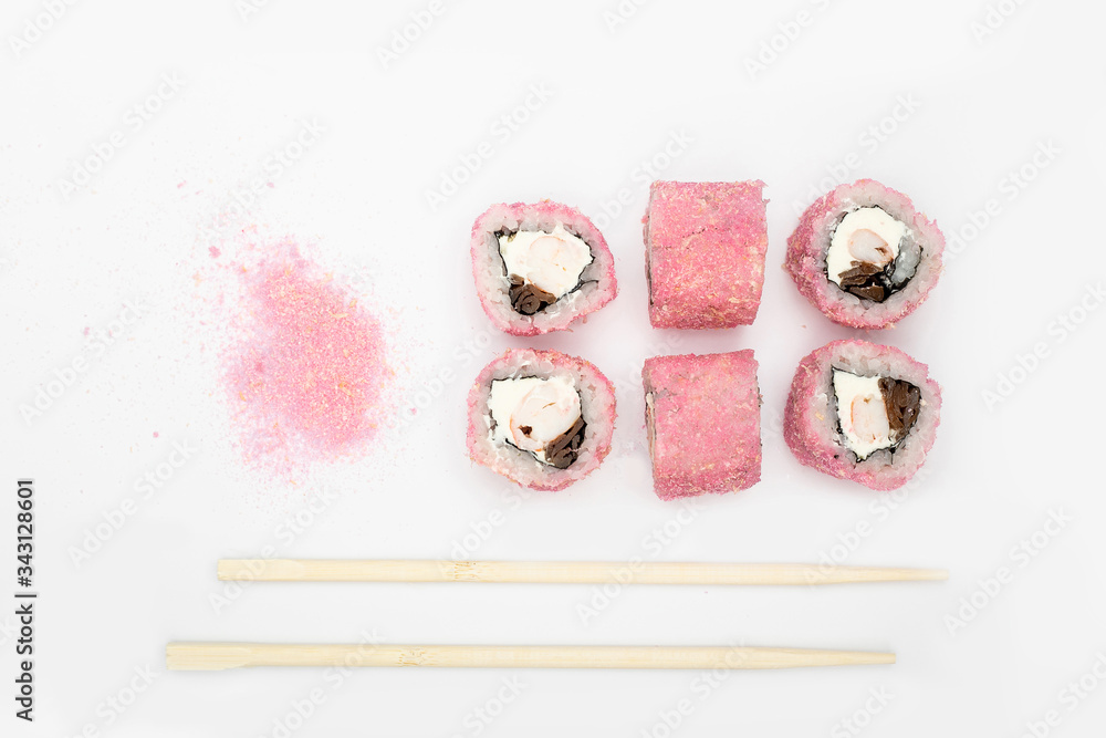 Japanese cuisine. Maki sushi. isolated on white background. Sushi rolls lie on a white background, top view, next to them are Japanese bamboo sticks. Concept idea for a japanese restaurant menu. Japanese cuisine. Maki sushi. isolated on white background. Sushi rolls lie on a white background, top view, next to them are Japanese bamboo sticks. Concept idea for a japanese restaurant menu.