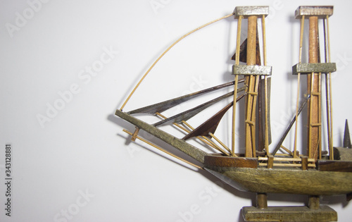 Close-up Ship of miniature hand made toy on rustic white background