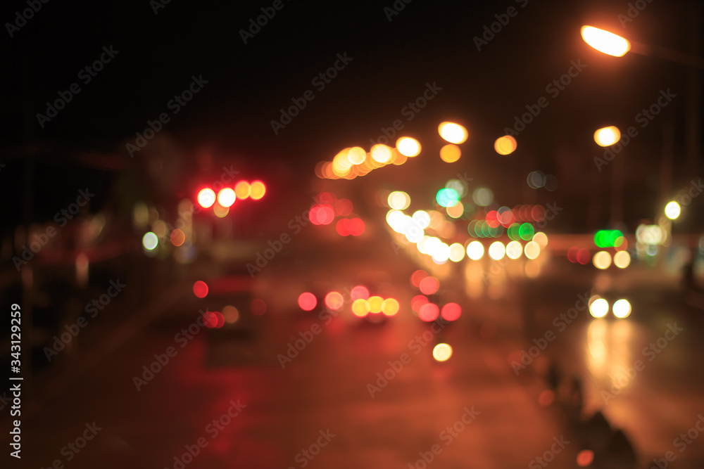 Blur image of inside cars with bokeh lights from traffic jam on night time for background.