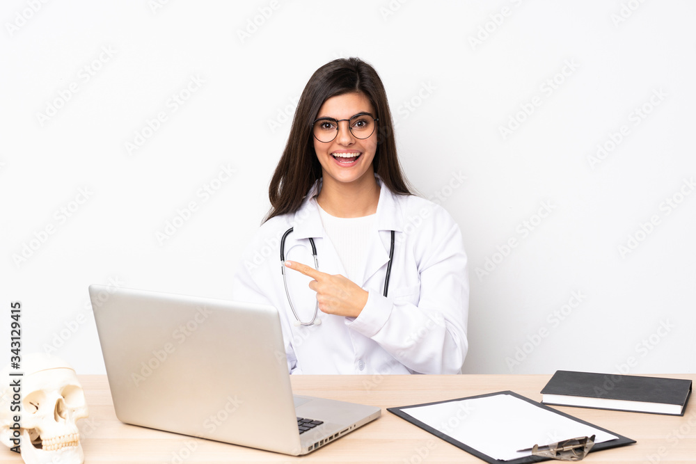 Professional traumatologist in workplace pointing finger to the side