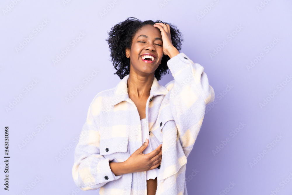 Young African American woman isolated on purple background smiling a lot Young African American woman isolated on purple background smiling a lot