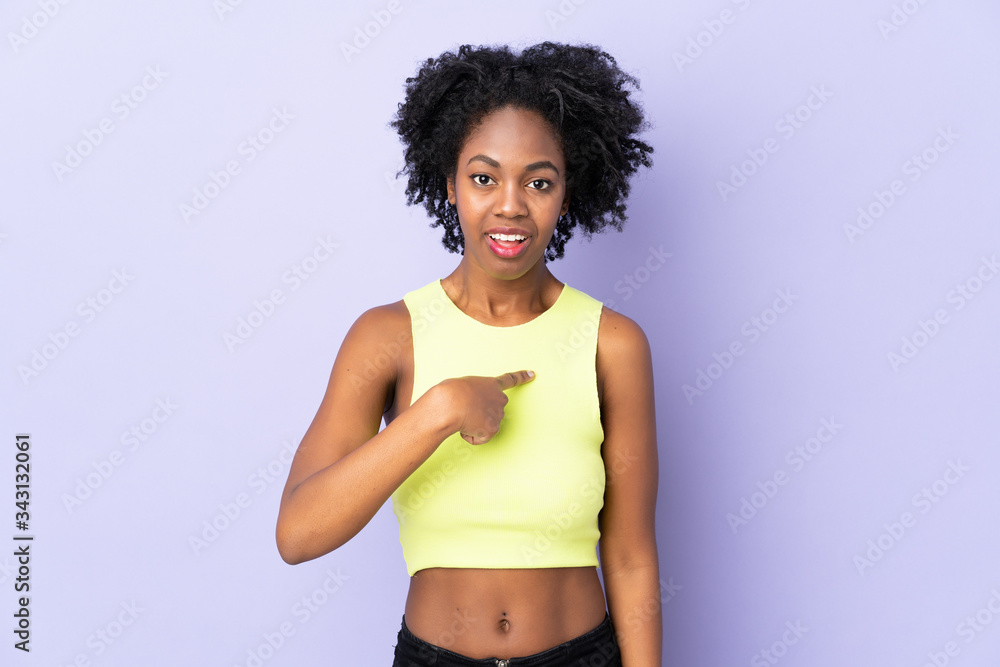Young African American woman isolated on purple background pointing to oneself