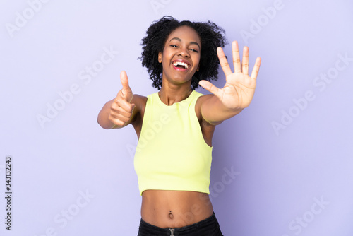 Young African American woman isolated on purple background counting six with fingers