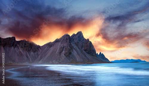 Scenic landscape with most breathtaking mountains Vestrahorn on the Stokksnes peninsula with the waves of the bay at sunset in Iceland. Exotic countries. Amazing places.