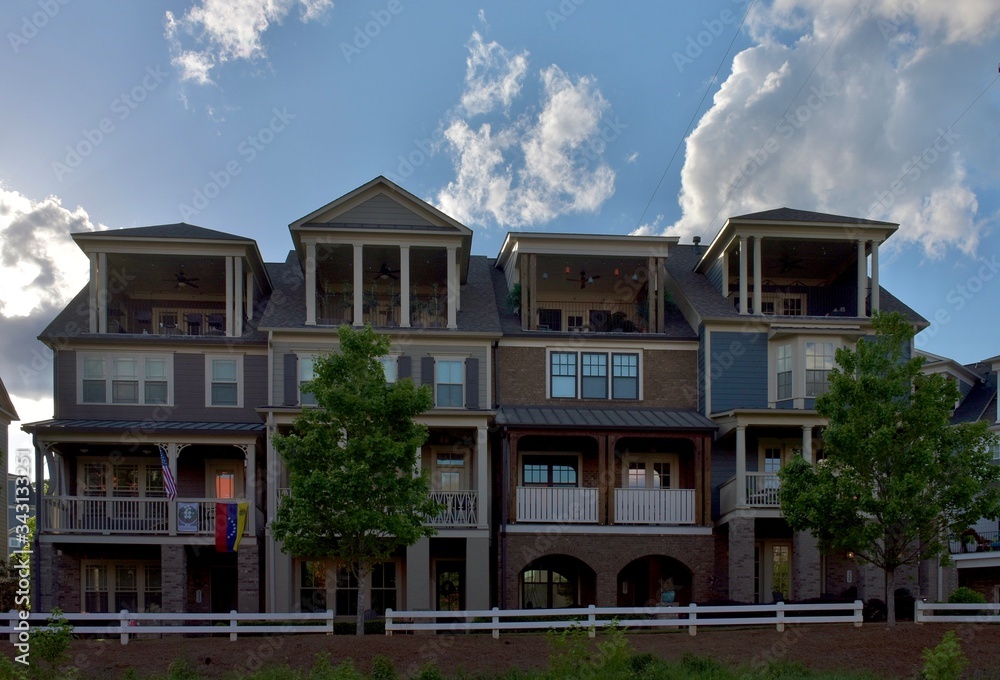 Fototapeta premium Row houses with a blue sky and clouds