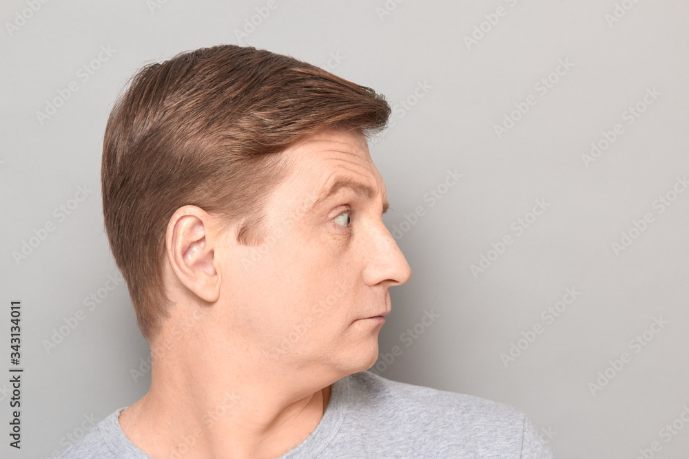 Fototapeta premium Portrait of blond mature man with incredulous expression on face