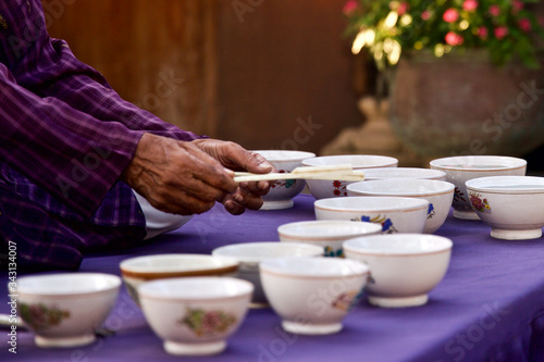 The Indian 'Jal Tarang' is a melodic percussion instrument. It consists of a set of ceramic or metal bowls filled with water, which are played by striking the edge with beaters, one in each hand.