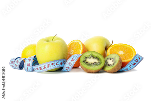 Measuring tape and fruits isolated on white background