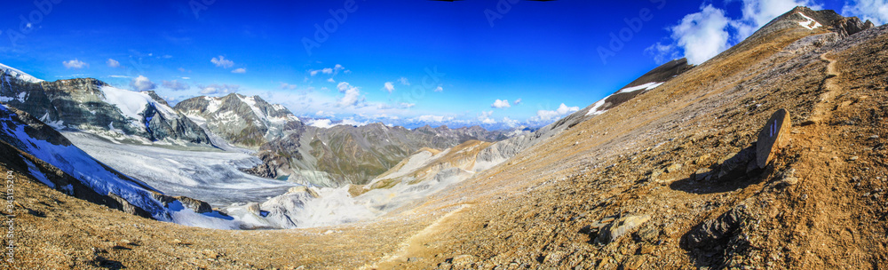 Dramatic panoramic view of a hiking trail in the swiss alps leading to the top of Barrhorn mountain at Canton Wallis in Switzerland
