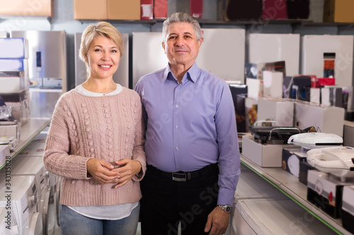 Woman and man are visiting shop of household appliances for buyi