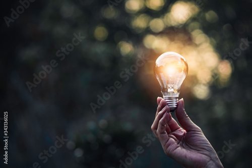 Innovation and energy concept of hand hold a light bulb and copy space for insert text.