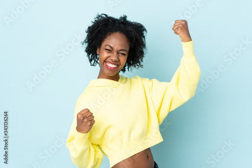 Canvas-taulu Young African American woman isolated on blue background celebrating a victory
