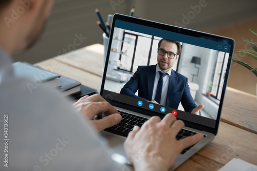 Close up laptop screen, businessman making video call, participating in online conference, typing on keyboard, business partners negotiations in internet, hr manager holding remote job interview