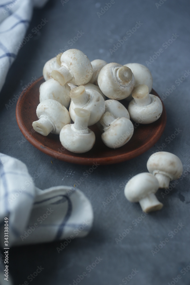 on a gray background in a plate of mushrooms on a gray background in a plate of mushrooms
