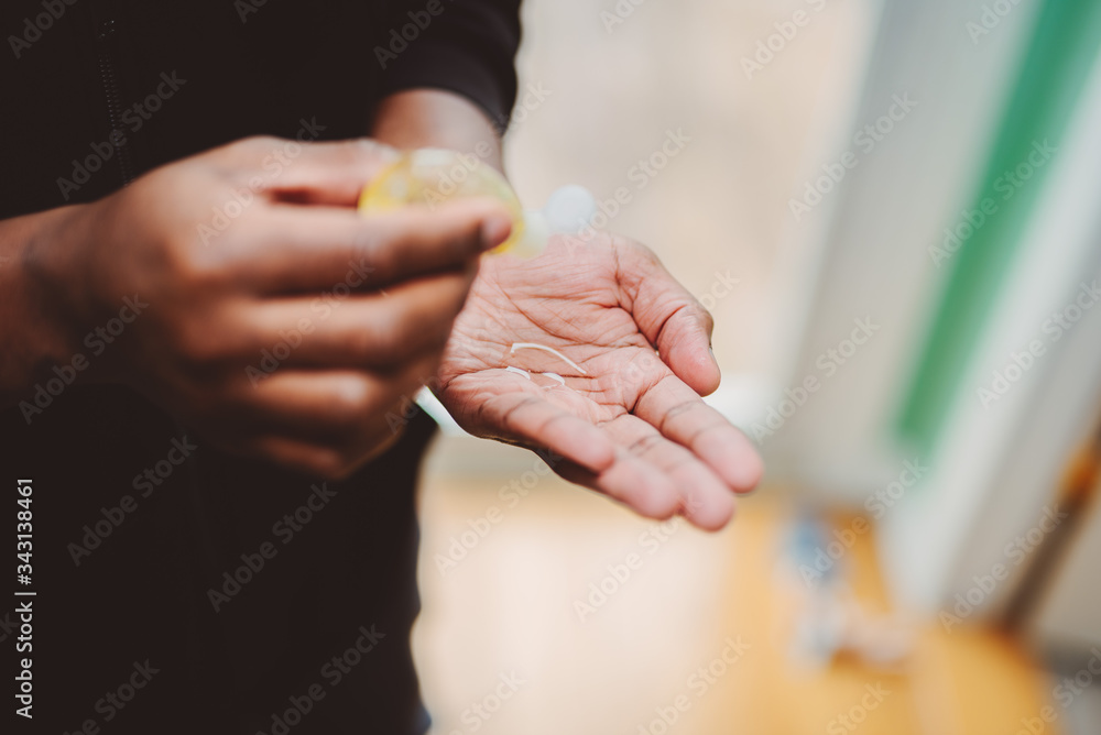 african american man using hand sanitizer african american man using hand sanitizer