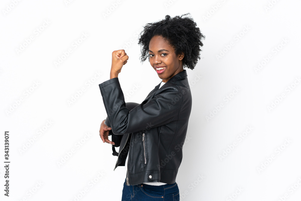 Young African American woman with a motorcycle helmet isolated on white background making strong gesture Young African American woman with a motorcycle helmet isolated on white background making strong gesture