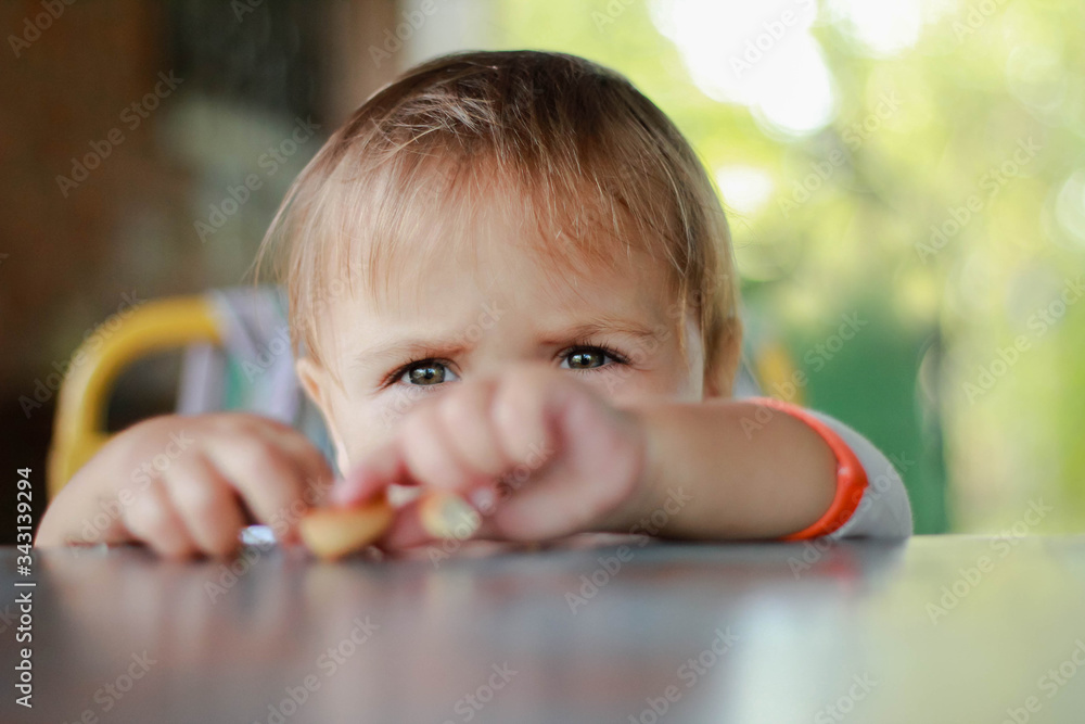 Portrait of a sad, focused child. Dark beautiful eye. Children, babies, people, health care, psychology, curiosity, sadness, feelings-concepts. Portrait of a sad, focused child. Dark beautiful eye. Children, babies, people, health care, psychology, curiosity, sadness, feelings-concepts.